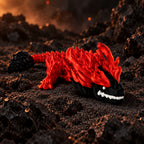 Rood met zwarte 3D-geprinte bloodfang baby draak in een sfeervolle vulkanische omgeving met rotsen en gloeidraden.